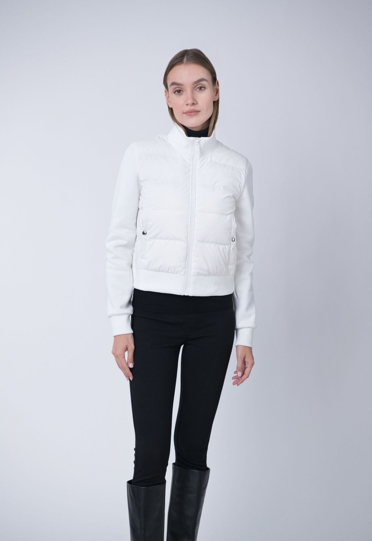 white puffer vest and knit sleeve jacket