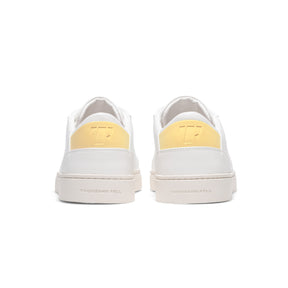 back view of ethically made sneakers with pastel yellow upper back heel detail
