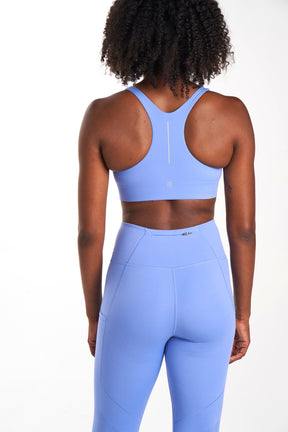 Back view sustainable sports bra in color iris (periwinkle)