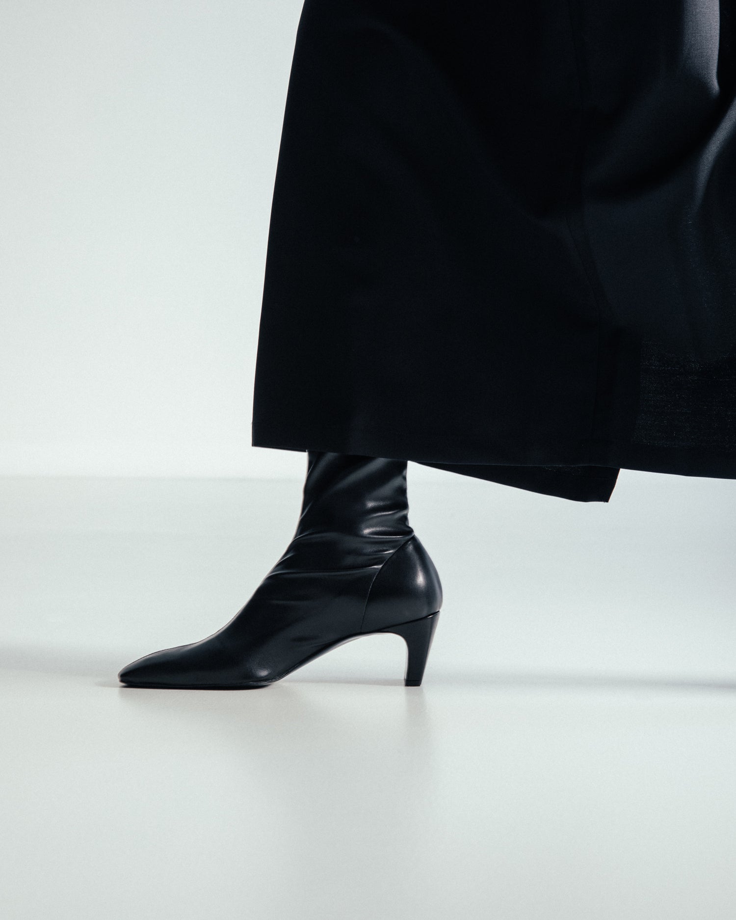 elegant black leather ankle booties made from sustainable materials