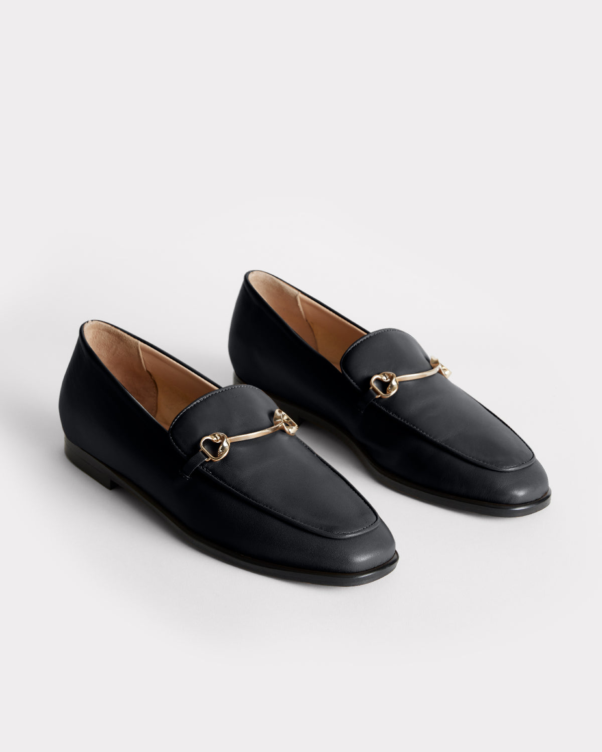 black leather slip on moccasin with recycled brass hardware