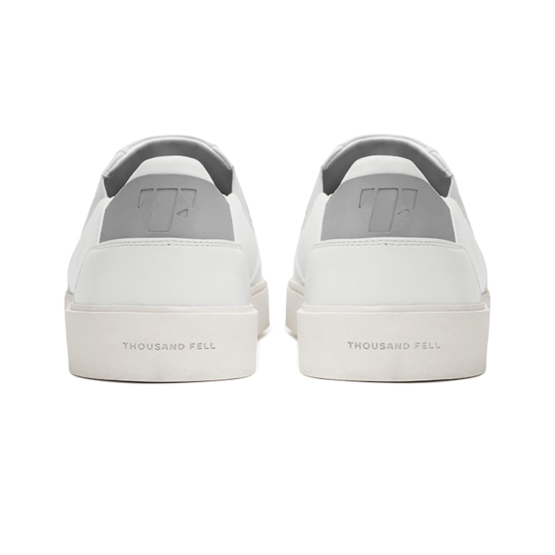 back view of white slip ons with grey upper heel