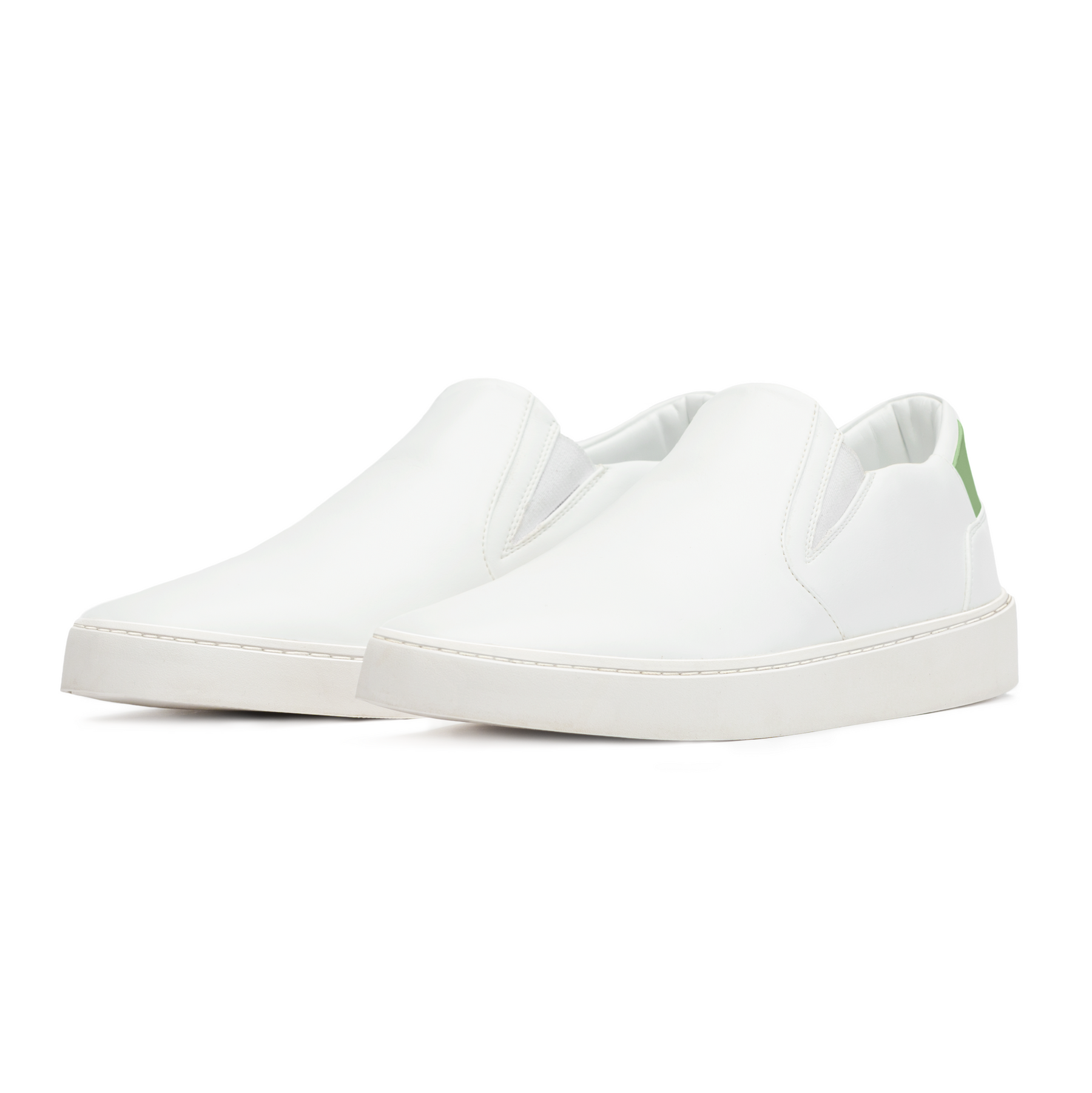 white slip ons with green upper back heel ethically made
