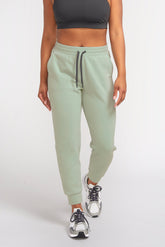 High waisted jogger made from merino wool and recycled polyester in color glacier (sage)