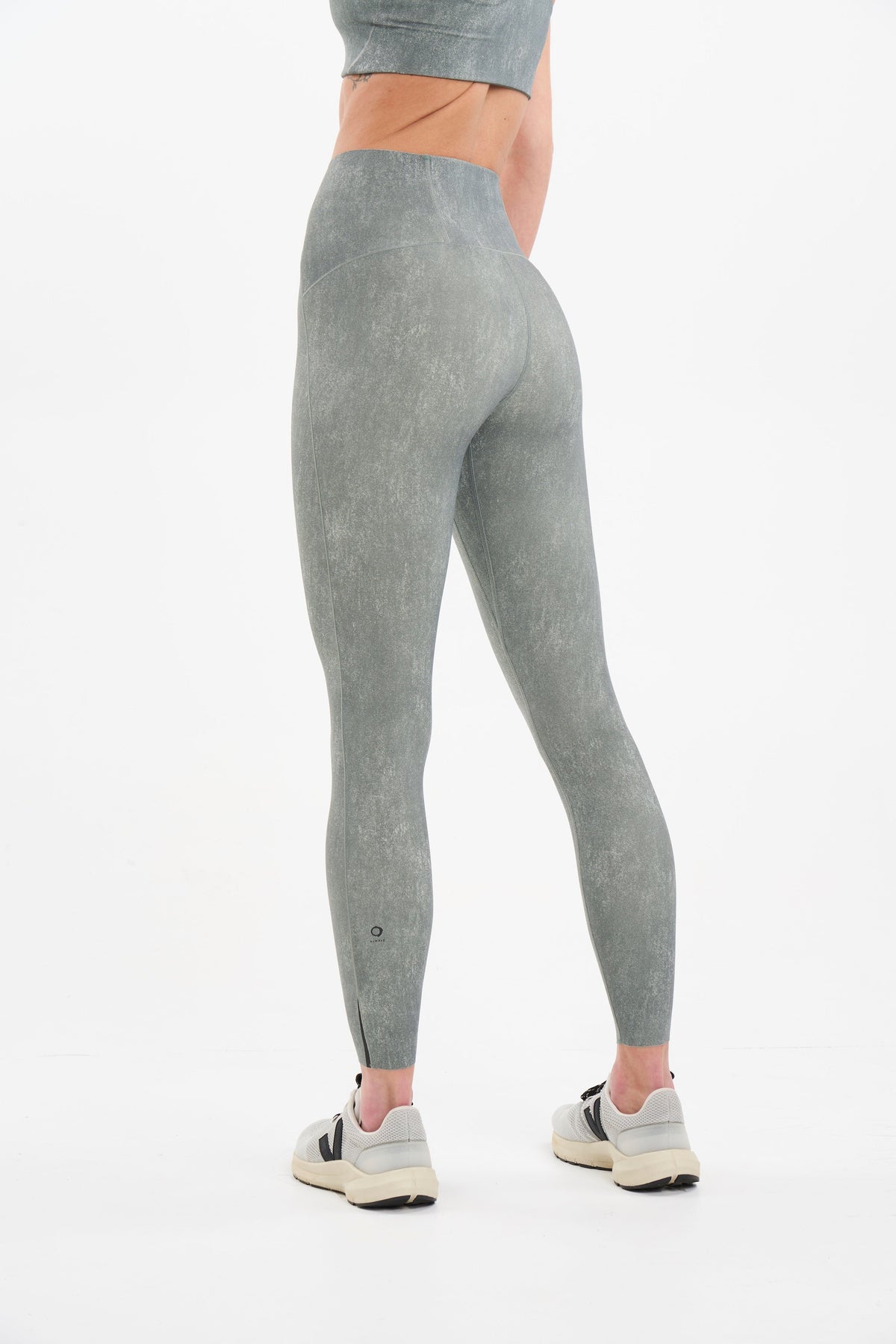 Back view of eco friendly high waisted compression tights for workout
