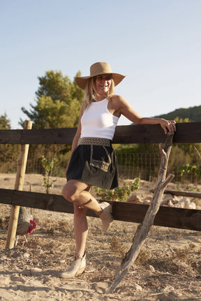 woman wearing beige vegan leather western boots
