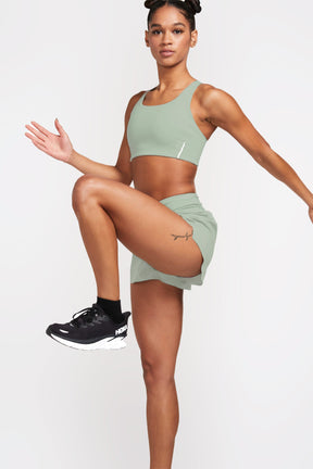 Active woman wearing lightweight workout shorts in glacier color